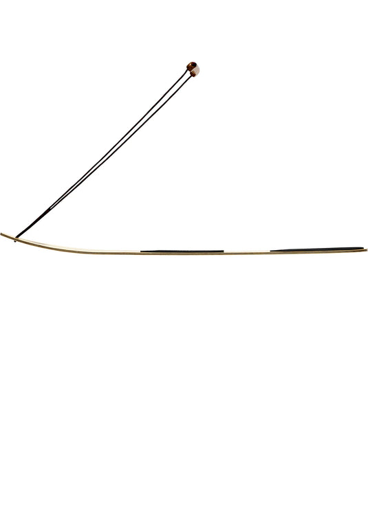 Side view of snowboard with string and nocks on a white background