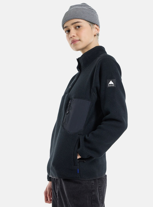 Person wearing a black fleece jacket with a Burton logo on a white background