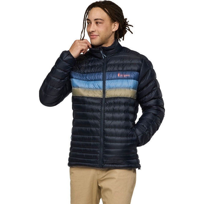 Man wearing a blue puffer jacket with color-blocked design on a white background
