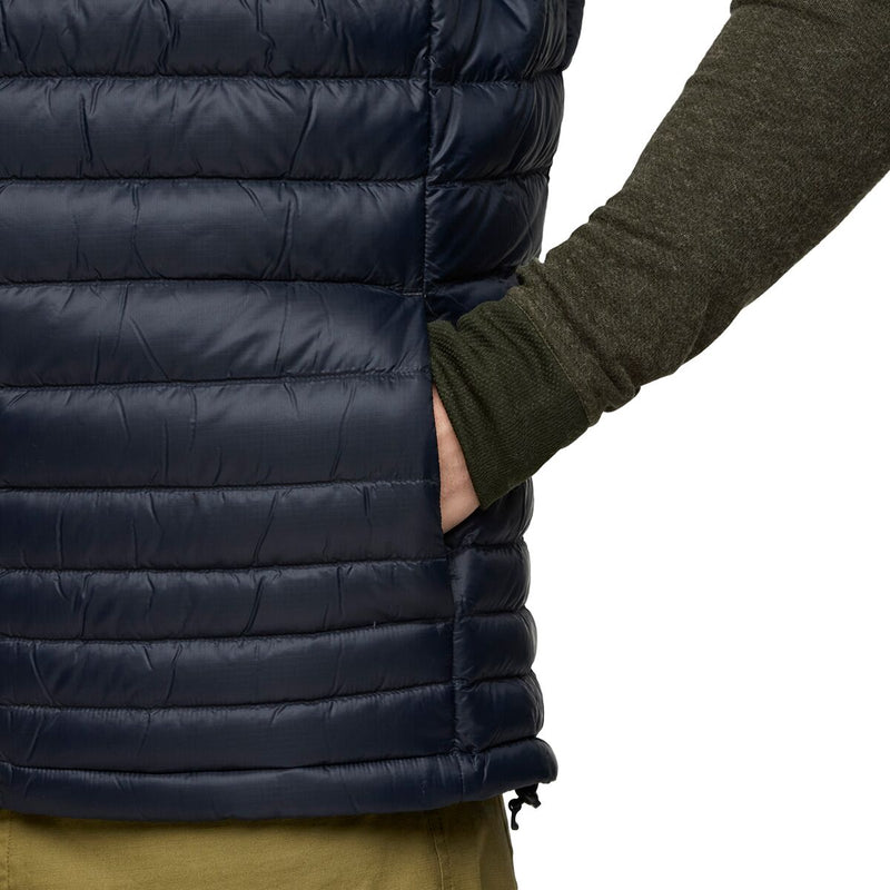 Load image into Gallery viewer, Navy blue puffer vest worn by a person with a white background
