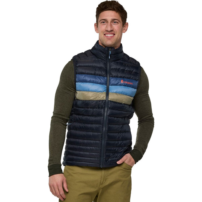 Man wearing a colorful puffer vest with a Cotopaxi logo on a white background