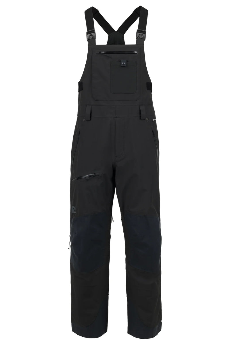 Load image into Gallery viewer, Black technical Flylow snow bib overalls with adjustable shoulder straps, a chest pocket, and reinforced knee panels. Ski and Tennis Station
