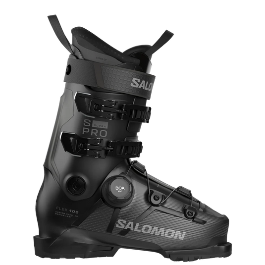 A Salomon supra 100 ski boot in matte black with gray branding and technical detailing, featuring a BOA dial closure system, shown on a solid white background. Ski and Tennis Station