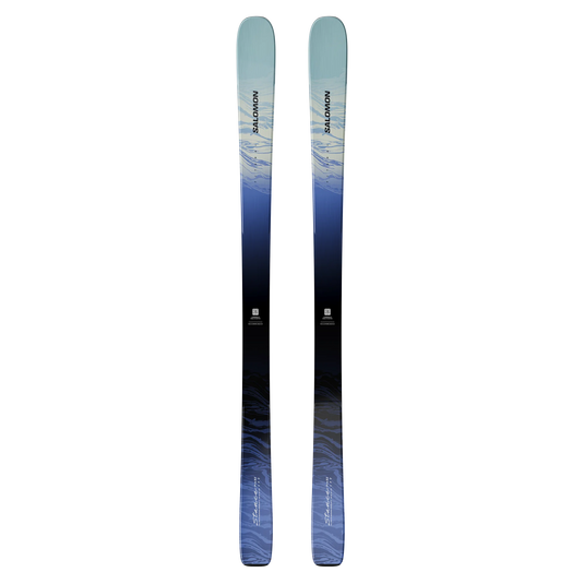 A pair of Salomon Stance 82 ski tips shown vertically against a solid white background, featuring a blue and black gradient design with white and blue abstract patterns. Ski and Tennis Station