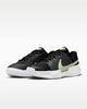 Black and green athletic shoes with a Nike logo on a white background