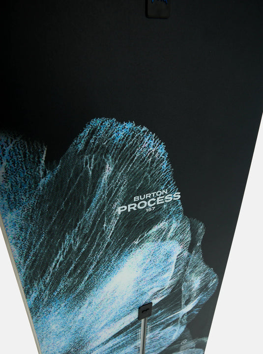 Close-up of a snowboard with a mountain and wave design.