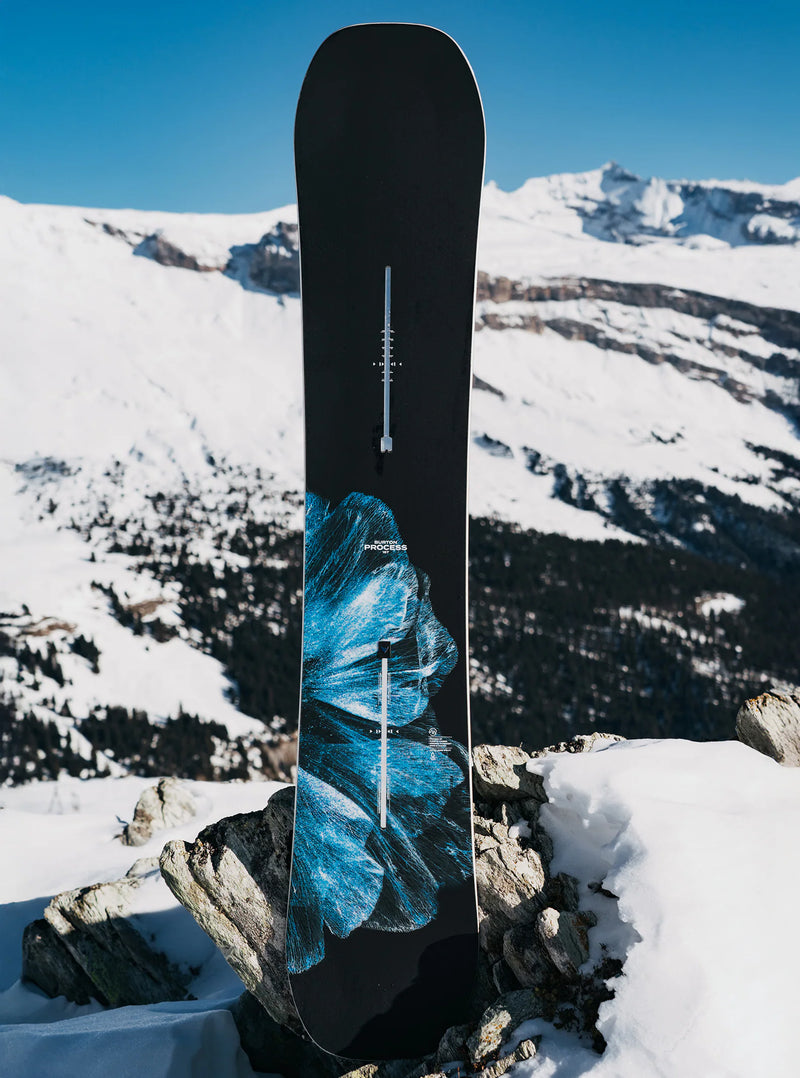 Load image into Gallery viewer, Snowboard with mountain design on a rocky outcrop with snowy mountains in the background.
