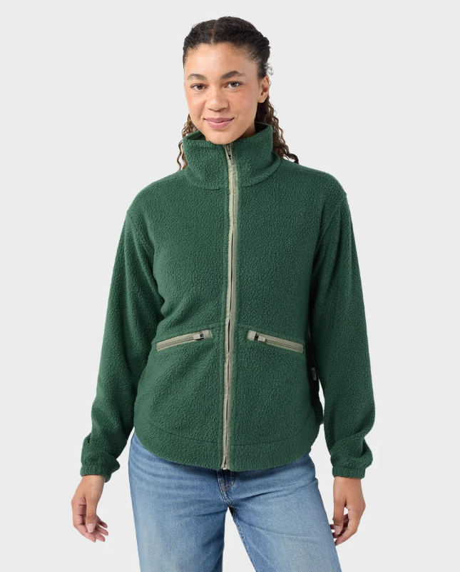 Load image into Gallery viewer, A woman modeling a medium green Stio Rawlins fleece jacket with a high collar, full-length front zipper, and two zippered hand pockets, Ski and Tennis Station
