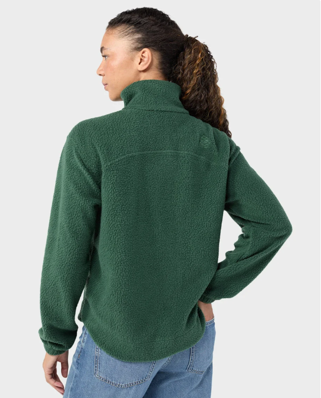 Load image into Gallery viewer, A woman modeling a medium green Stio Rawlins fleece jacket with a high collar, full-length front zipper, and two zippered hand pockets, Ski and Tennis Station
