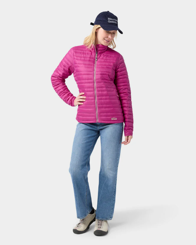 Load image into Gallery viewer, A woman wearing a bright pink Stio puffer jacket with a high collar and front zipper. Ski and Tennis Station
