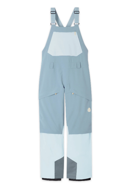 Colorblock Stio Skyrider snow bib overalls in light blue, pale blue, and gray, featuring adjustable shoulder straps and multiple utility pockets, shown flat on a white background.