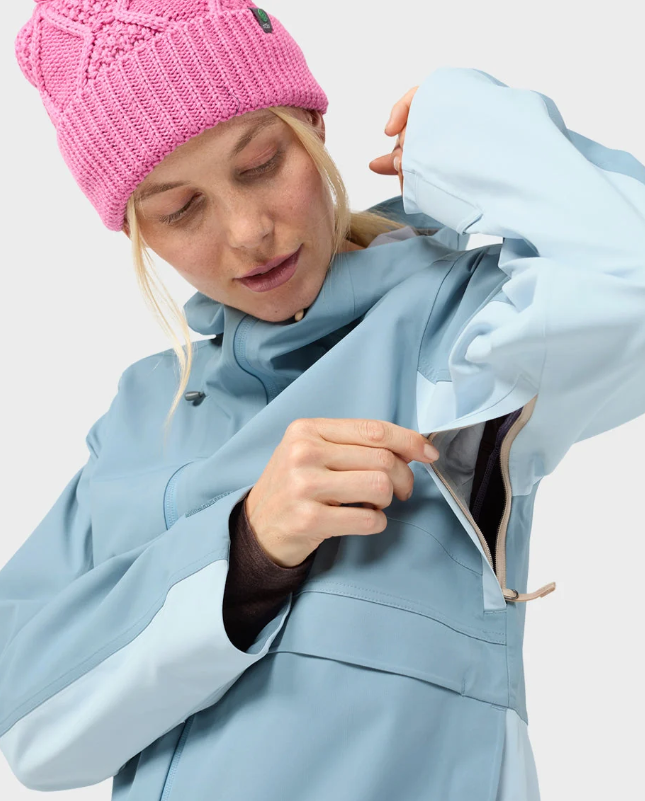 Load image into Gallery viewer, A woman wearing a light blue Stio skyrider ski jacket with contrasting pale blue panels and a pink knit beanie. Ski and Tennis Station
