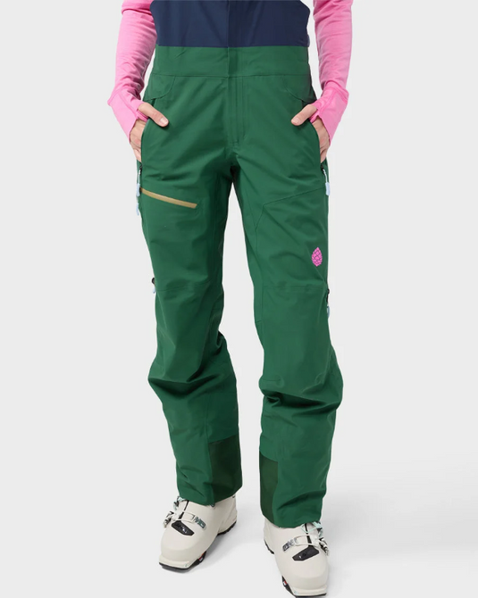 A pair of dark green Stio ski bib pants with a navy blue chest panel, gray adjustable suspenders. Ski and Tennis Station