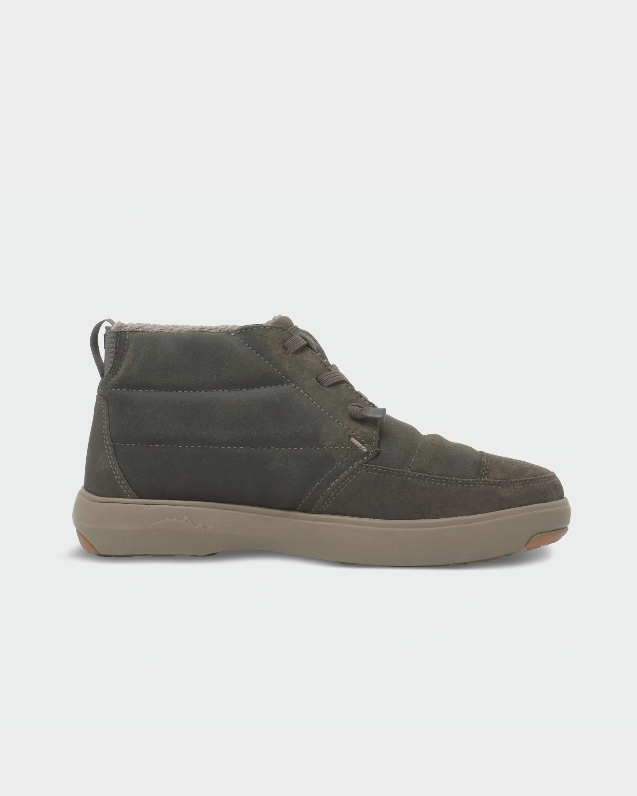 Load image into Gallery viewer, A single mid-cut lace-up Stio shoe in dark olive green suede and fabric, featuring a thick tan sole. Ski and Tennis Station
