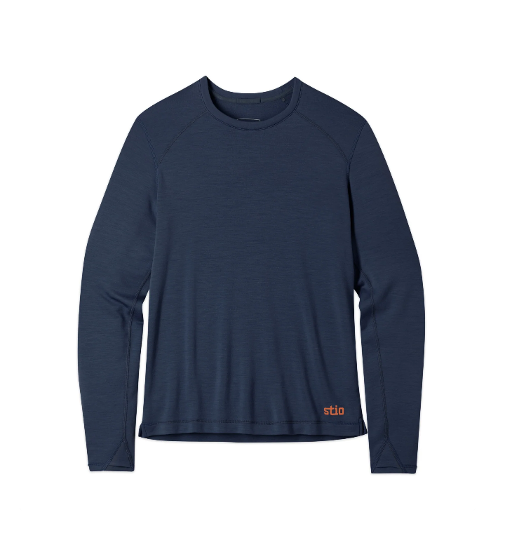 Load image into Gallery viewer, A navy blue long-sleeve performance shirt with raglan sleeves and a small orange 'stio' logo near the bottom right hem, Ski and Tennis Station
