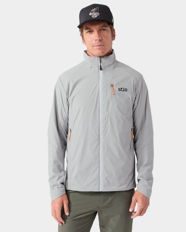 Load image into Gallery viewer, A man wearing a light gray Stio jacket with a black cap. Ski and Tennis Station
