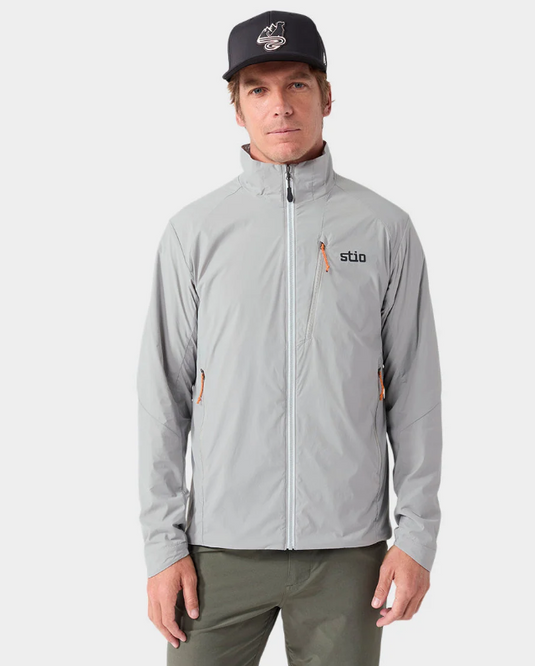 A man wearing a light gray Stio jacket with a black cap. Ski and Tennis Station