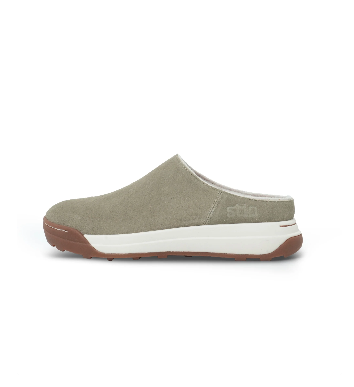 Load image into Gallery viewer, A single slip-on clog-style shoe in muted sage green suede, featuring a thick white midsole and a brown outsole. Ski and Tennis Station
