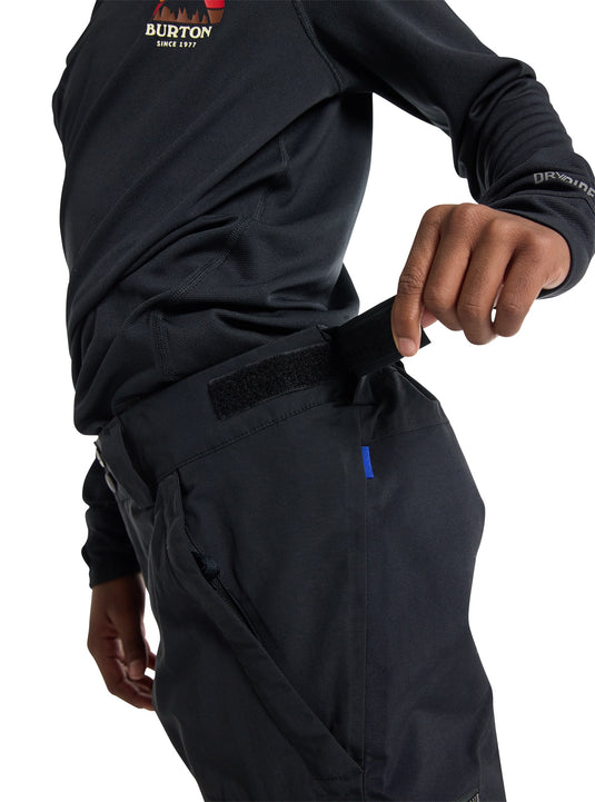 Person wearing black Burton pants with a white background