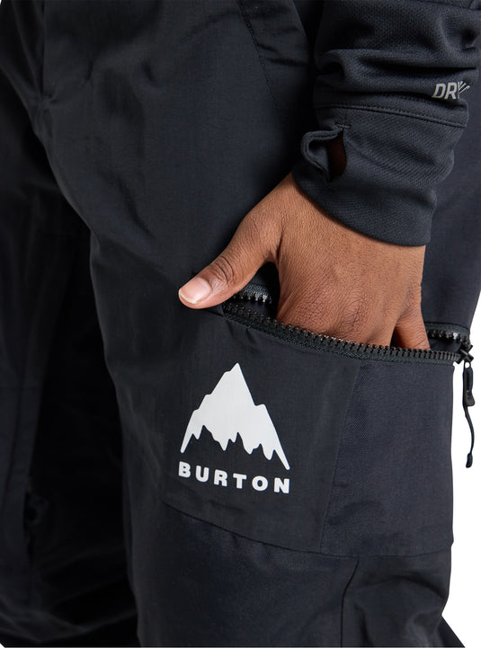 Black Burton snow pants with a mountain logo on a white background