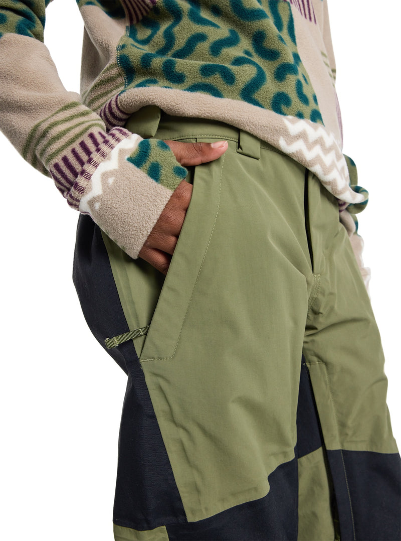 Load image into Gallery viewer, Person wearing a patterned sweater and green snow pants on a white background
