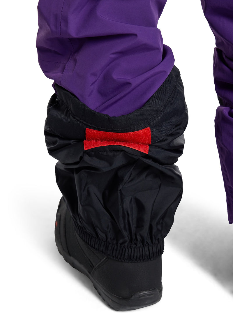 Load image into Gallery viewer, Black leg warmers with a red logo worn over purple pants on a white background
