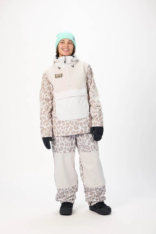 Person wearing a leopard print snowsuit with the Trenchover jacket from Airblaster. Ski and Tennis Station
