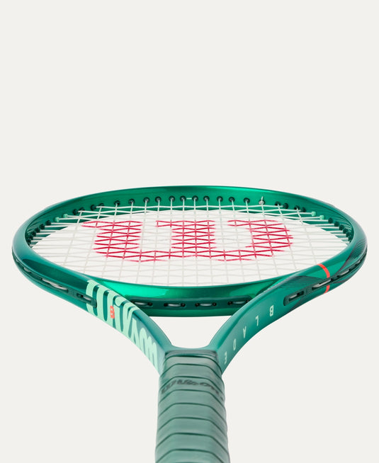 Green tennis racket with Wilson logo on a white background