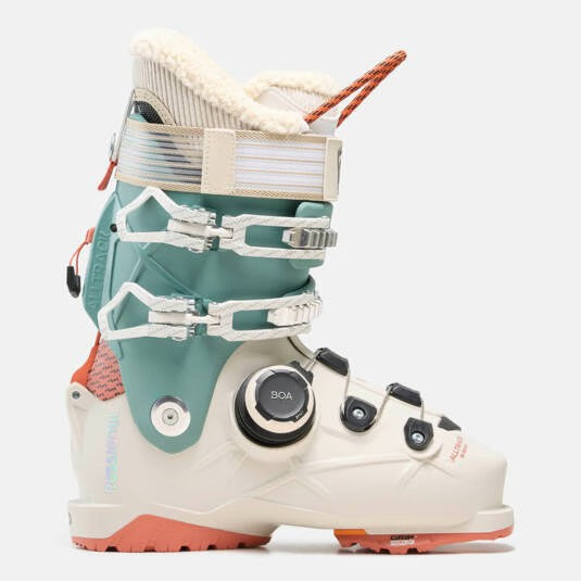Load image into Gallery viewer, A Rossignol women's alltrack ski boot shown in profile against a light gray background. The boot features a white and teal lower shell with a mint green upper cuff, a cream strap, a black dial closure system, and coral orange accents on the outsole and heel. Ski and Tennis Station

