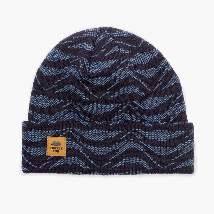 Navy and blue patterned beanie with a visible brand label on a white background