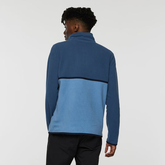 Person wearing a blue pullover with a black stripe on a white background