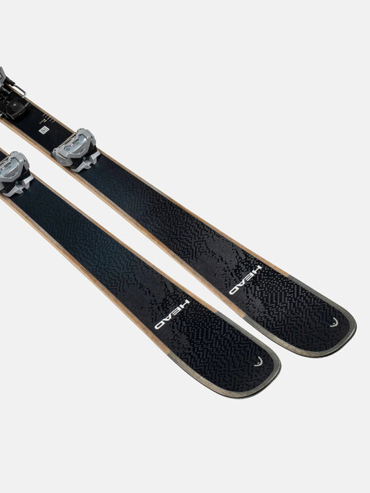 Pair of black skis with bindings on a light gray background
