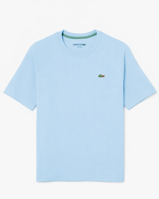 Light blue t-shirt with Lacoste logo on a white background