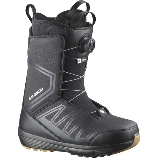 Black snow boot with visible Salomon branding on a white background. Ski and Tennis Station