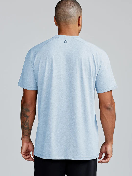 Load image into Gallery viewer, Man wearing a light blue t-shirt with a logo on the back against a gray background
