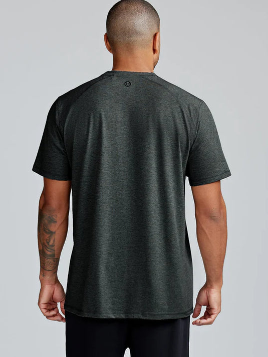 Man wearing a dark gray t-shirt on a plain background